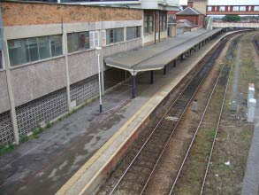 Severely spalled concrete wall at a train station